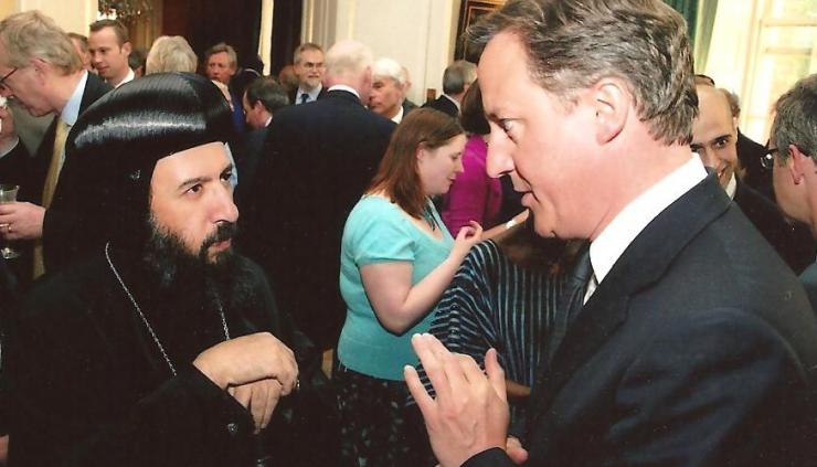 Prime Minister David Cameron speaks with Bishop Angaelos to offer condolences following the death of Coptic Christians in Libya